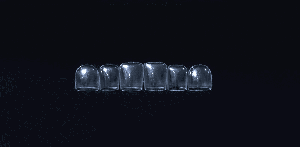 Row of six clear glass tumblers